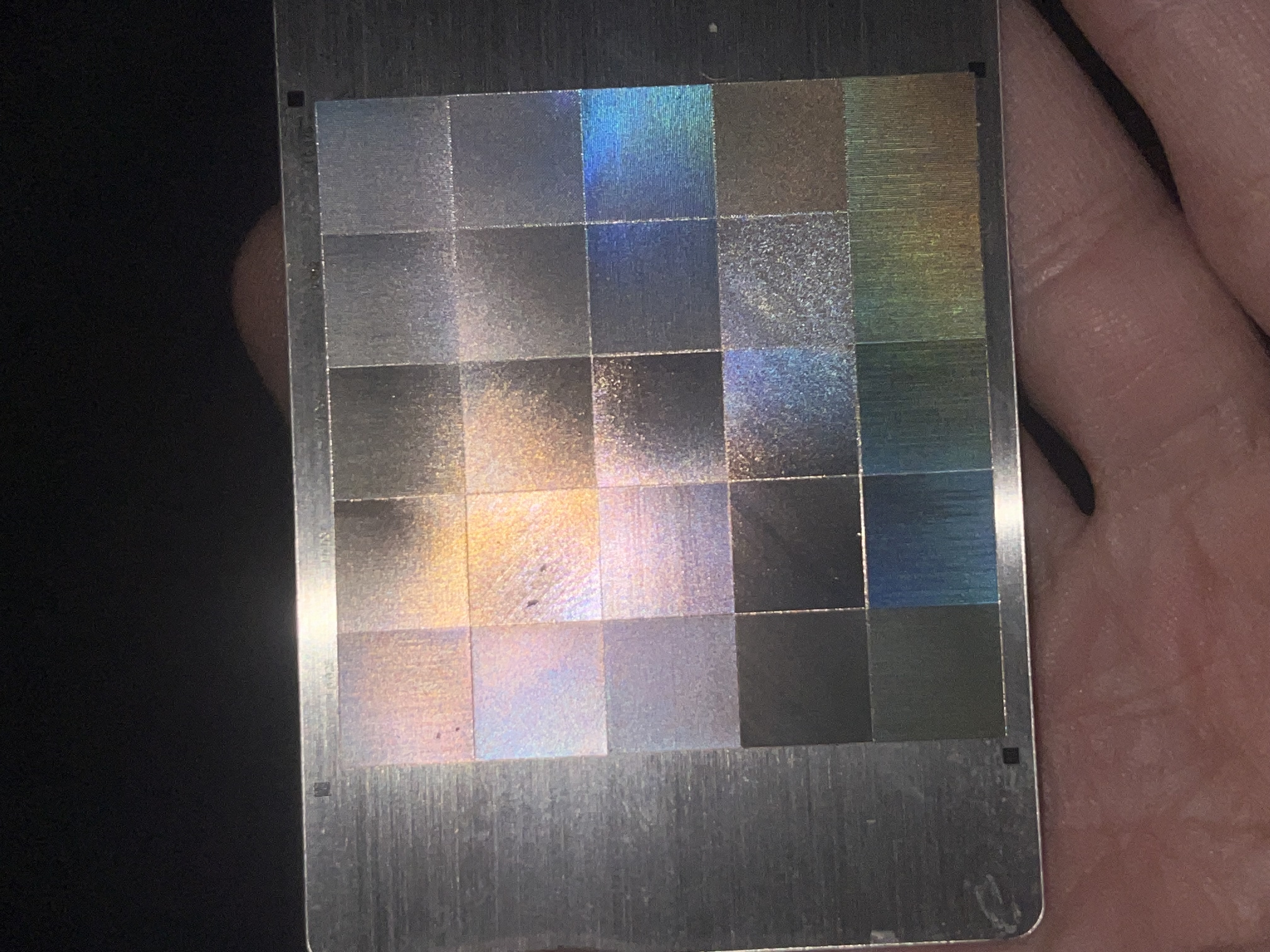 Physical fauxlographic calibration grid showing different iridescent responses under direct light